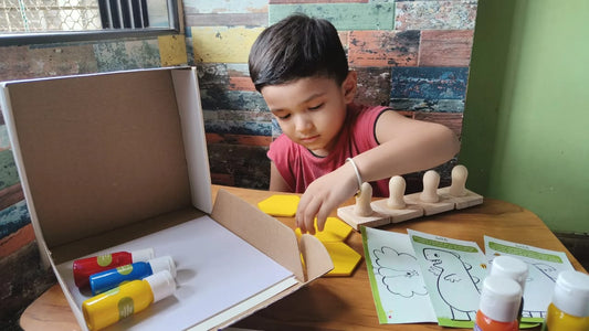 Kid is printing and learning shapes