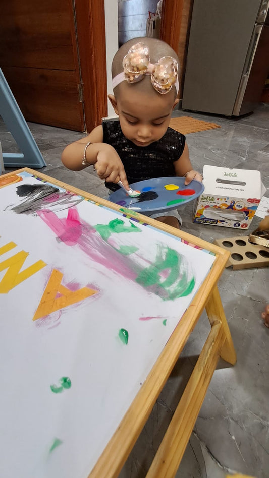 1 year baby loves to paint with jumbo brushes